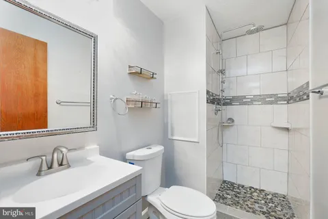 a bathroom with a sink toilet and shower