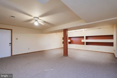 a view of an empty room with a ceiling fan
