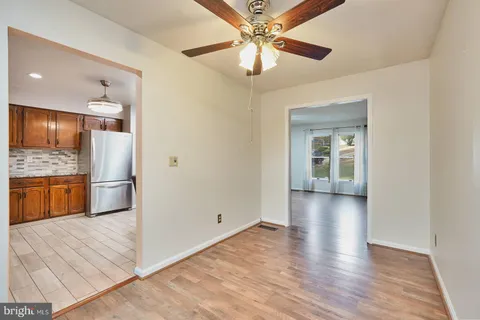 a view of a kitchen with a sink and a refrigerator