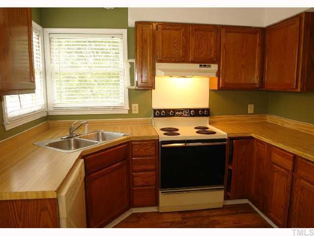 4412 Roller Court Raleigh, NC 27604 - Photo 6 of 12 a kitchen with a sink stove and cabinets