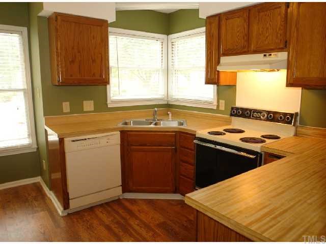 4412 Roller Court Raleigh, NC 27604 - Photo 7 of 12 a kitchen with stainless steel appliances granite countertop a sink stove and refrigerator