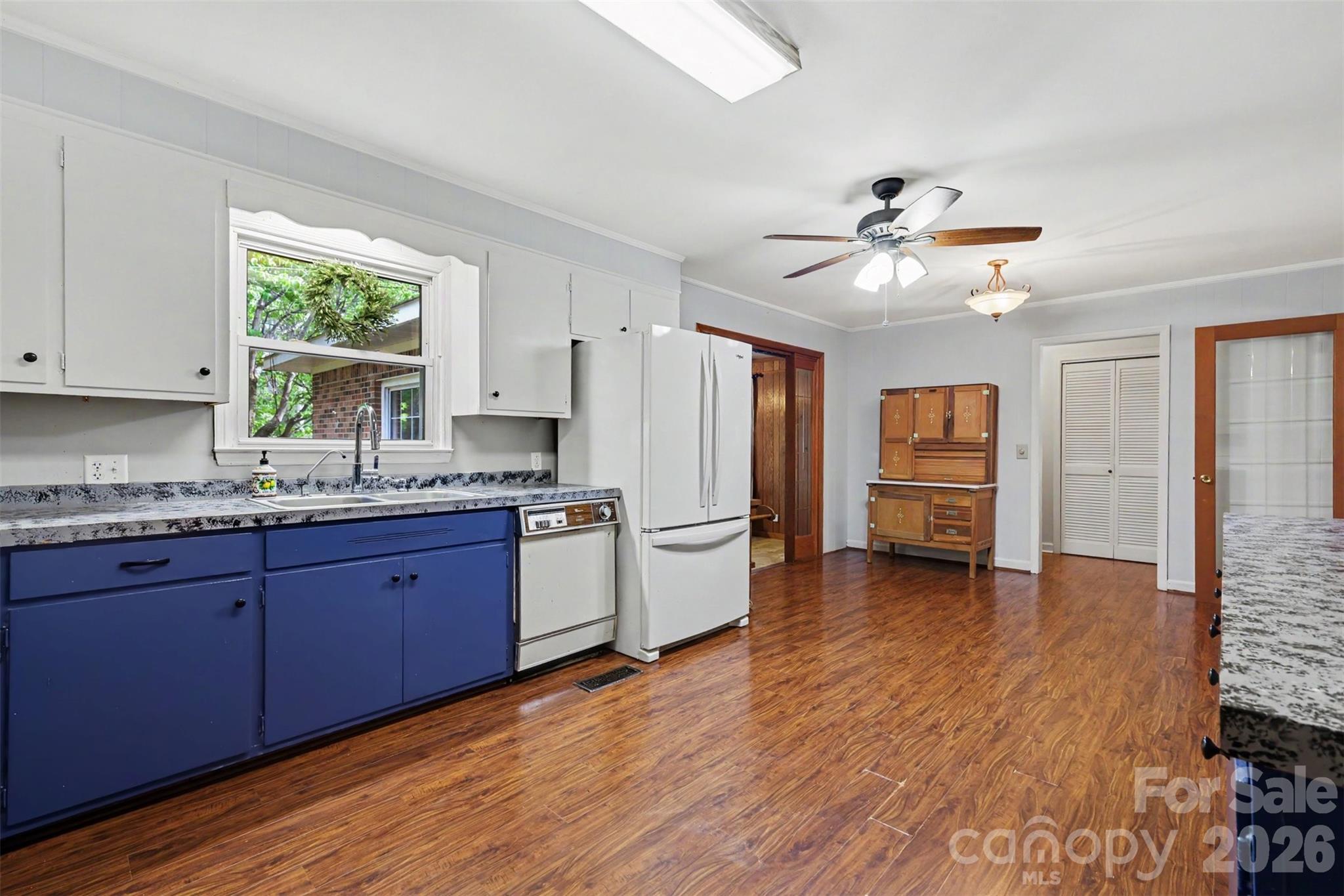 6774 Woodhaven Road Kershaw, SC 29067 - Photo 16 of 30 a kitchen with stainless steel appliances granite countertop a stove a sink dishwasher and a refrigerator with wooden floor
