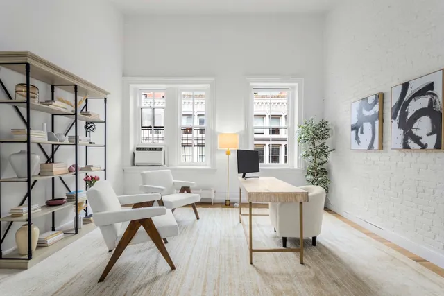 a workspace with furniture and a wooden floor