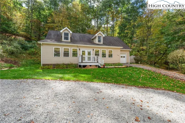 a front view of a house with a garden and plants