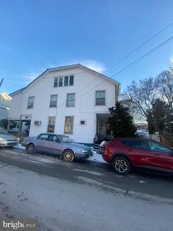 a front view of a house with parking space