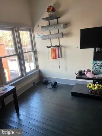a room with lots of wooden furniture and a flat screen tv