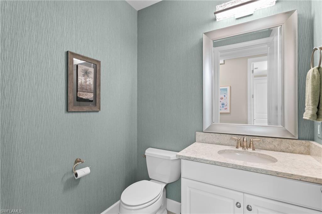 9684 Montelanico Loop, Unit 101 Naples, FL 34119 - Photo 22 of 49 Bathroom featuring vanity and toilet