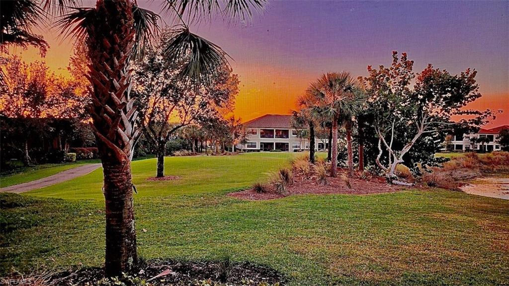 9684 Montelanico Loop, Unit 101 Naples, FL 34119 - Photo 26 of 49 View of yard at dusk