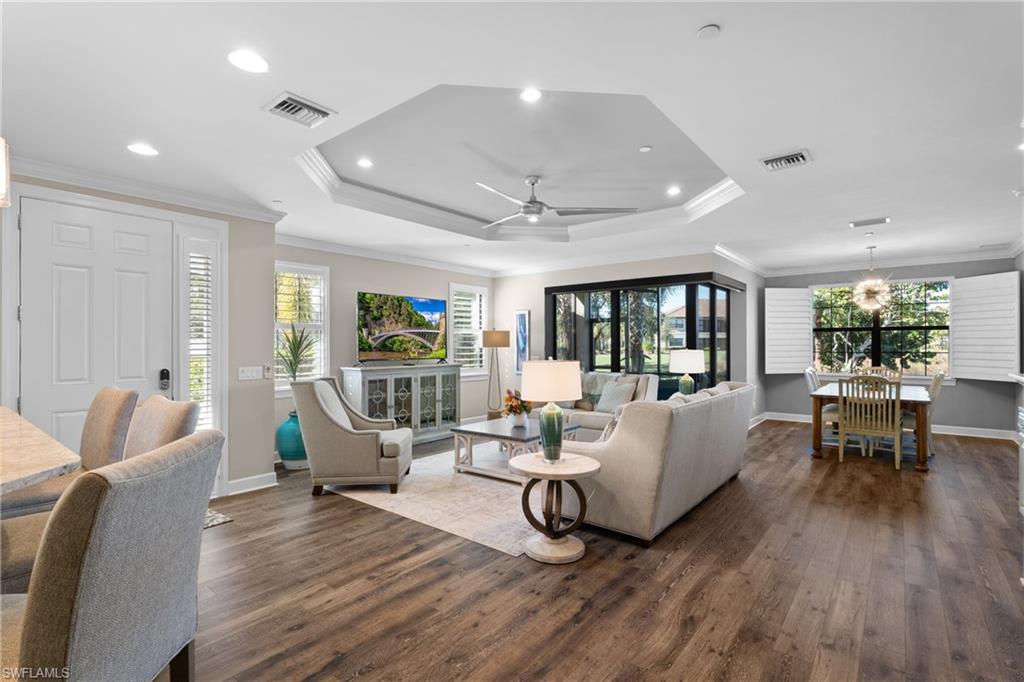 9684 Montelanico Loop, Unit 101 Naples, FL 34119 - Photo 3 of 49 Living room featuring dark hardwood / wood-style floors, a healthy amount of sunlight, ornamental molding, and ceiling fan