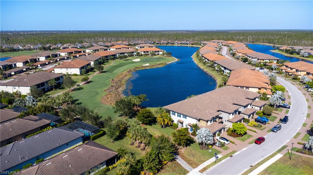 9684 Montelanico Loop, Unit 101 Naples, FL 34119 - Photo 32 of 49 Drone / aerial view with a water view