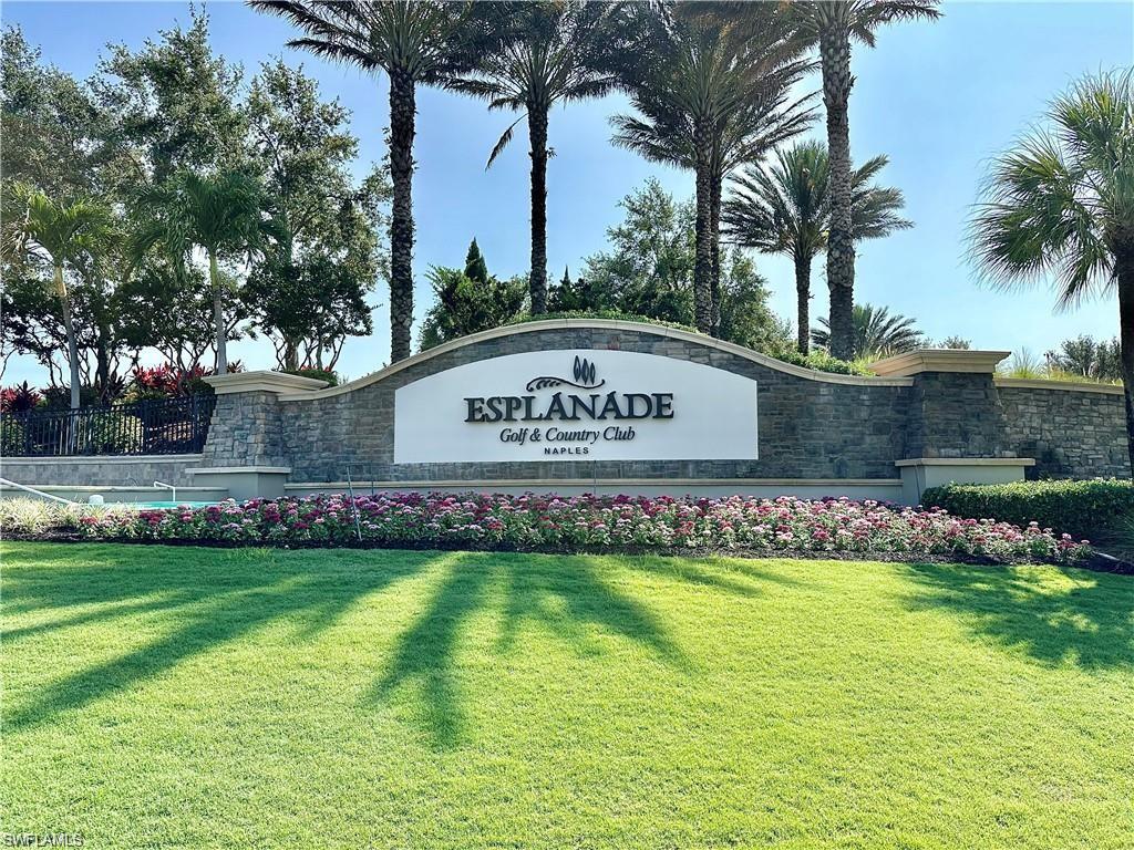 9684 Montelanico Loop, Unit 101 Naples, FL 34119 - Photo 35 of 49 Community sign with a yard