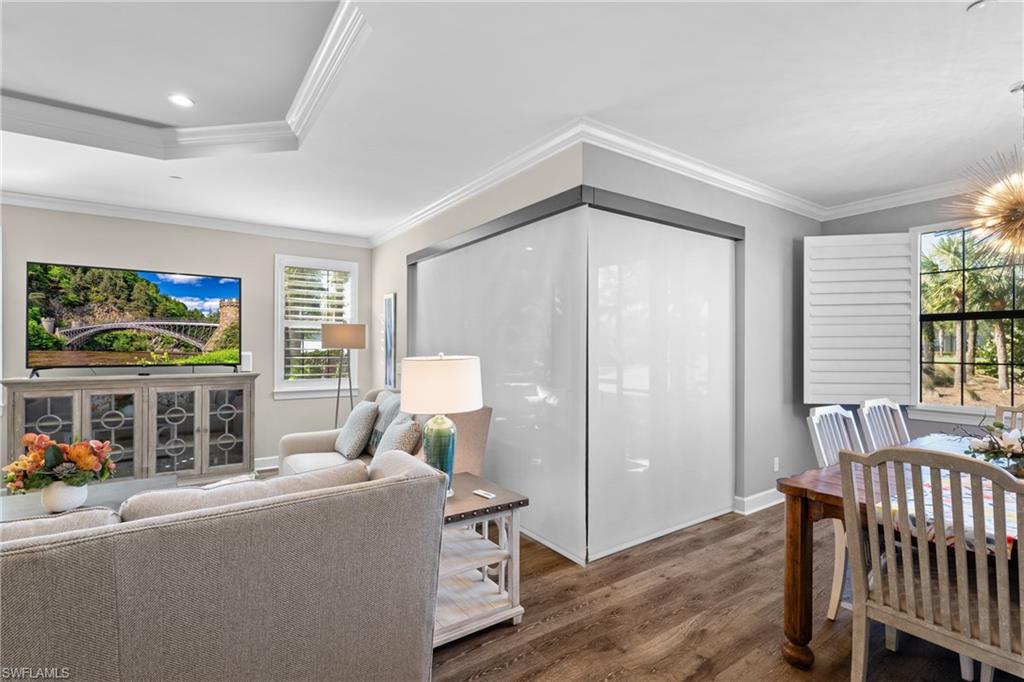 9684 Montelanico Loop, Unit 101 Naples, FL 34119 - Photo 7 of 49 Living room featuring hardwood / wood-style floors and crown molding
