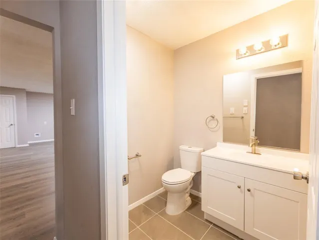 a bathroom with a sink a toilet and a large mirror