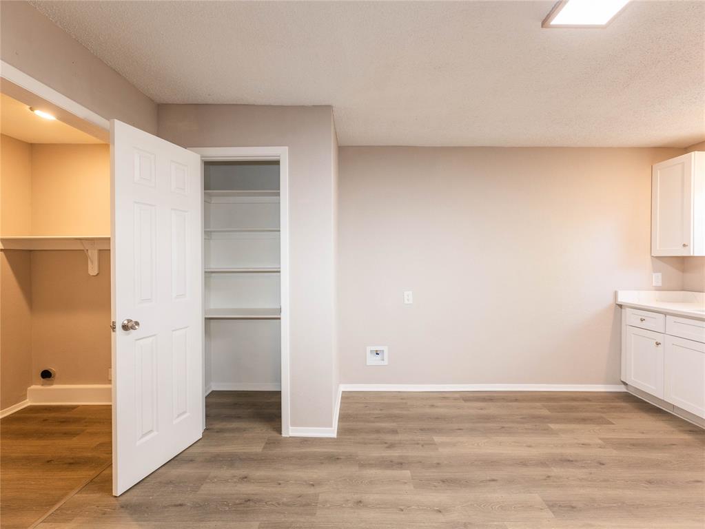1932 Mars Drive Garland, TX 75040 - Photo 20 of 27 a view of a room with wooden floor and cabinet