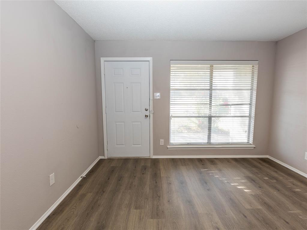 1932 Mars Drive Garland, TX 75040 - Photo 2 of 27 an empty room with wooden floor and windows
