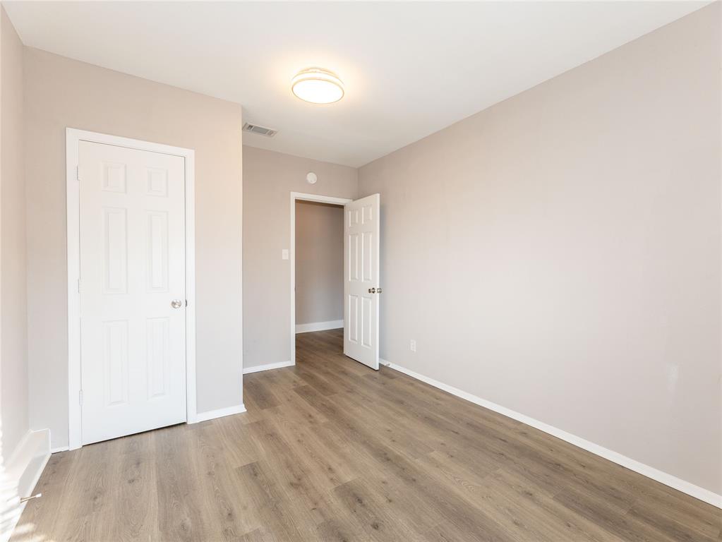 1932 Mars Drive Garland, TX 75040 - Photo 23 of 27 a view of an empty room with wooden floor
