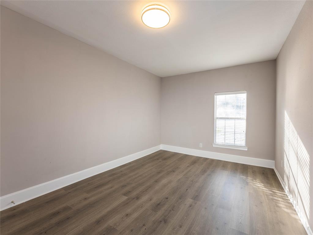 1932 Mars Drive Garland, TX 75040 - Photo 24 of 27 an empty room with wooden floor and windows
