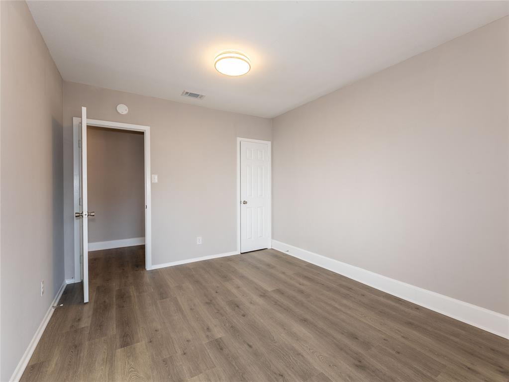 1932 Mars Drive Garland, TX 75040 - Photo 25 of 27 a view of an empty room with wooden floor