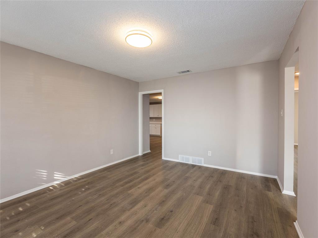 1932 Mars Drive Garland, TX 75040 - Photo 3 of 27 a view of an empty room with wooden floor