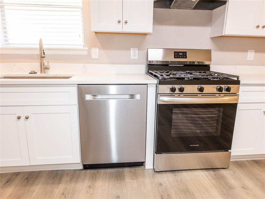 1932 Mars Drive Garland, TX 75040 - Photo 10 of 27 a kitchen with stainless steel appliances granite countertop a stove a microwave and a refrigerator