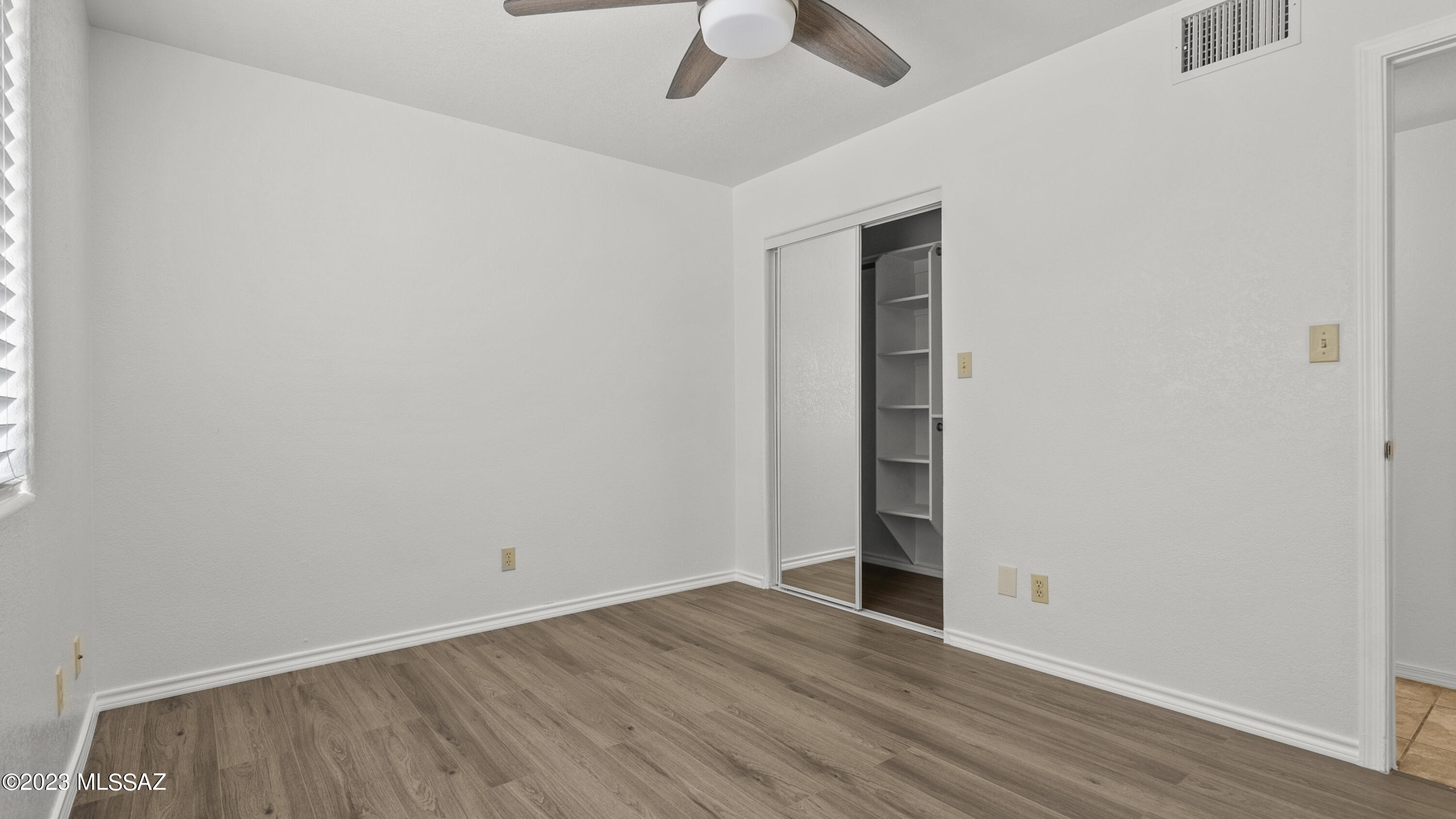1299 Imuris Court Rio Rico, AZ 85648 - Photo 14 of 18 an empty room with closet and a ceiling fan