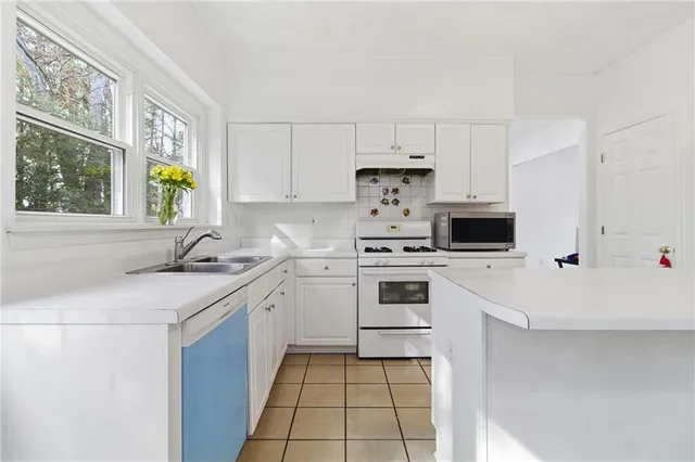 a kitchen with a sink stove and microwave