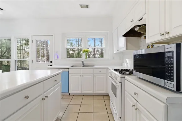 a spacious bathroom with a granite countertop sink mirror and window