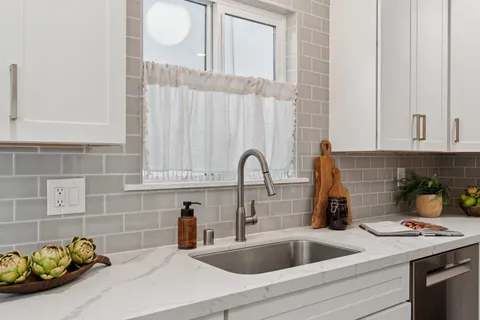 a kitchen with stainless steel appliances granite countertop a refrigerator sink and stove