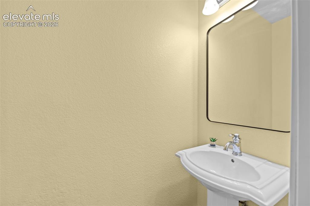16540 Mesquite Road Peyton, CO 80831 - Photo 20 of 50 a bathroom with a sink and a mirror