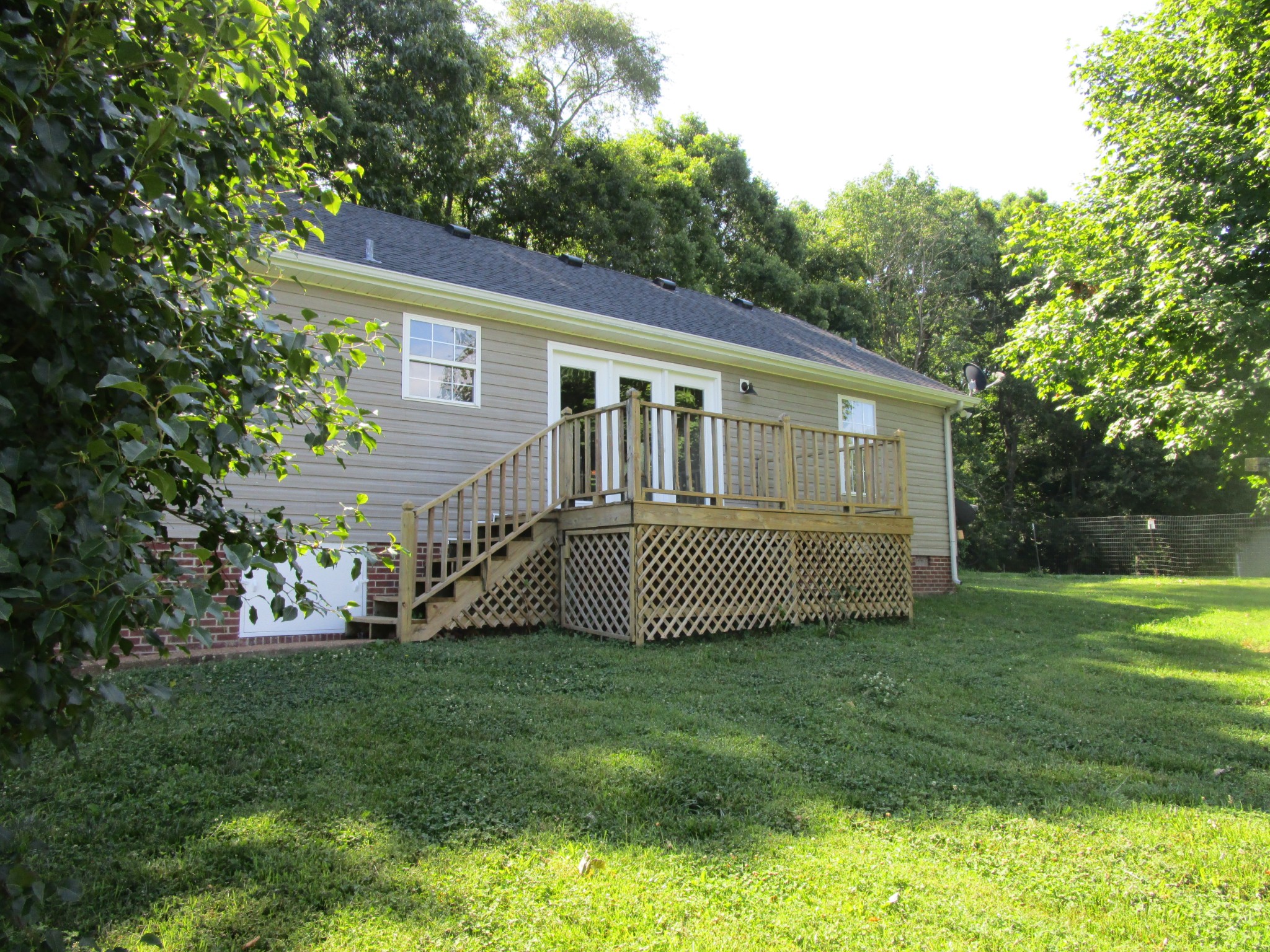 619 Lear Road Portland, TN 37148 - Photo 14 of 43 a front view of a house with a garden
