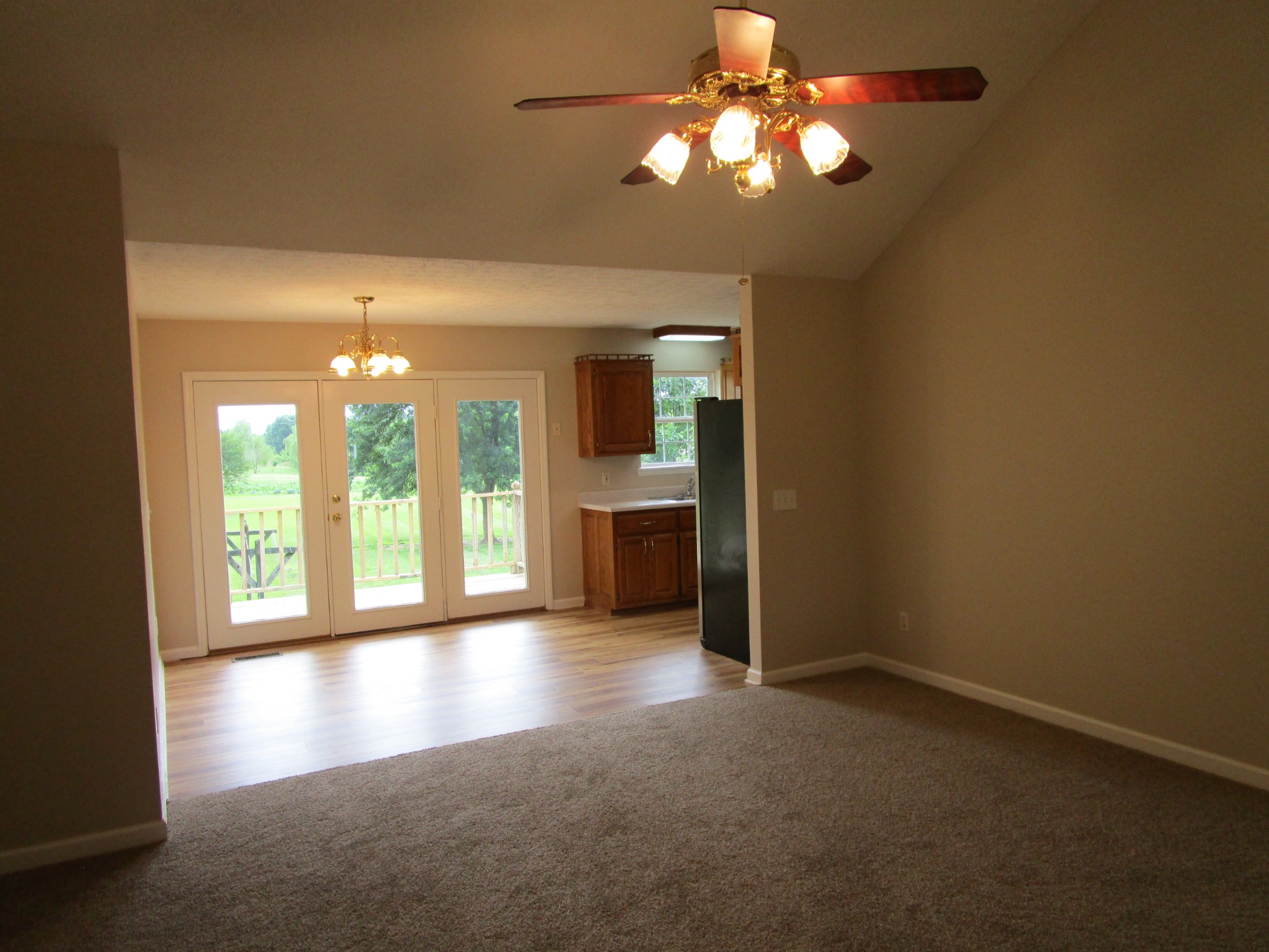 619 Lear Road Portland, TN 37148 - Photo 18 of 43 a view of a room with a chandelier fan and a kitchen view