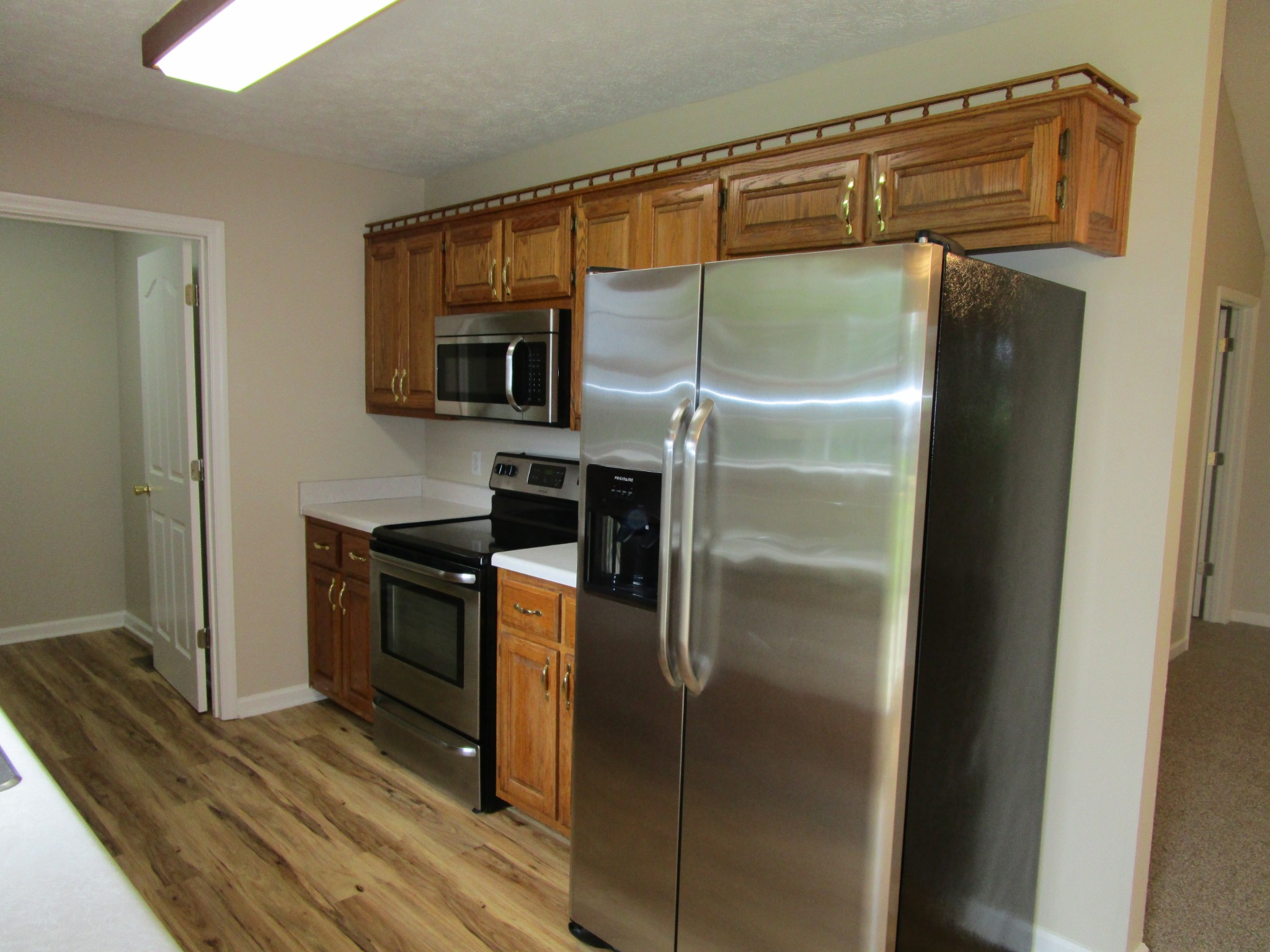 619 Lear Road Portland, TN 37148 - Photo 28 of 43 a kitchen with a refrigerator and a stove top oven