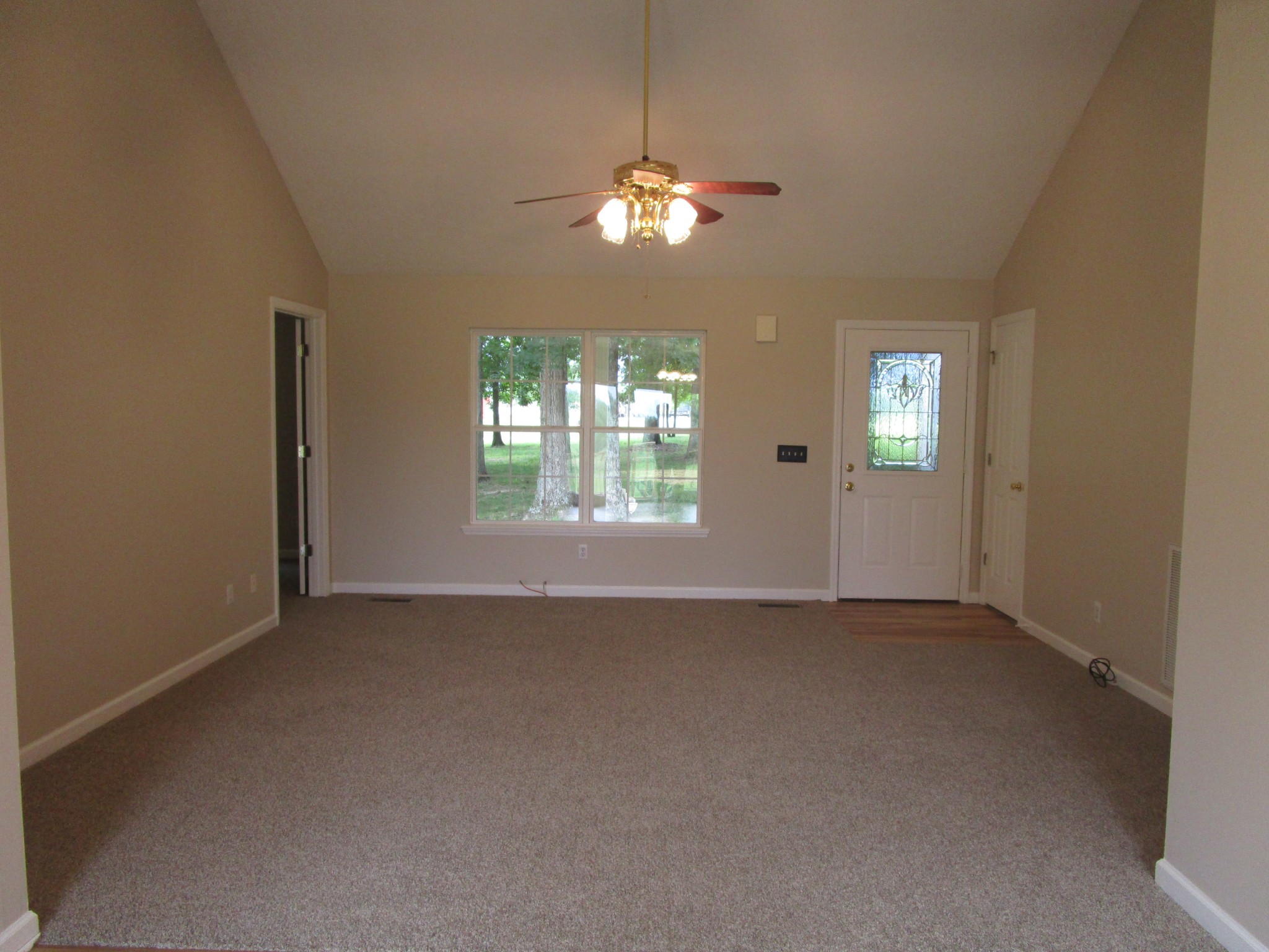 619 Lear Road Portland, TN 37148 - Photo 30 of 43 an empty room that has a chandelier fan and windows