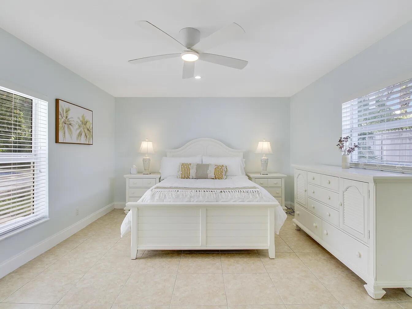 1310 Manor Drive Singer Island, FL 33404 - Photo 14 of 25 a spacious bedroom with a bed and a window