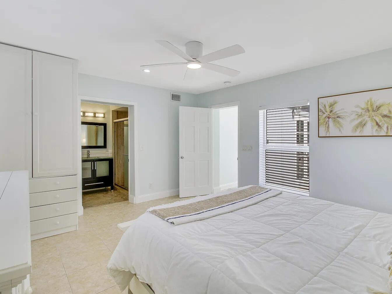 1310 Manor Drive Singer Island, FL 33404 - Photo 15 of 25 a bedroom with a bed and a window