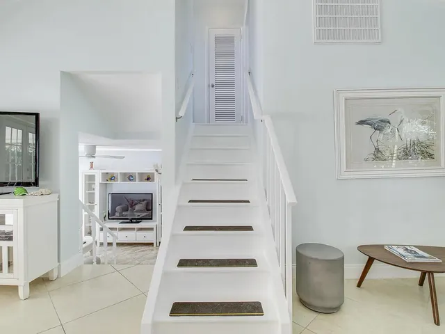 a view of a livingroom with furniture and staircase