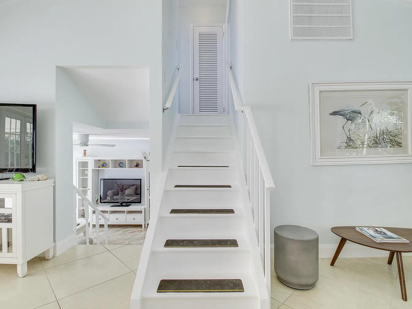 1310 Manor Drive Singer Island, FL 33404 - Photo 17 of 25 a view of a livingroom with furniture and staircase