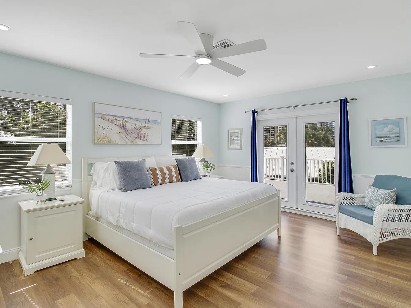 1310 Manor Drive Singer Island, FL 33404 - Photo 18 of 25 a bedroom with a large bed and a couch