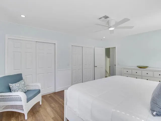 a spacious bedroom with a bed and a couch