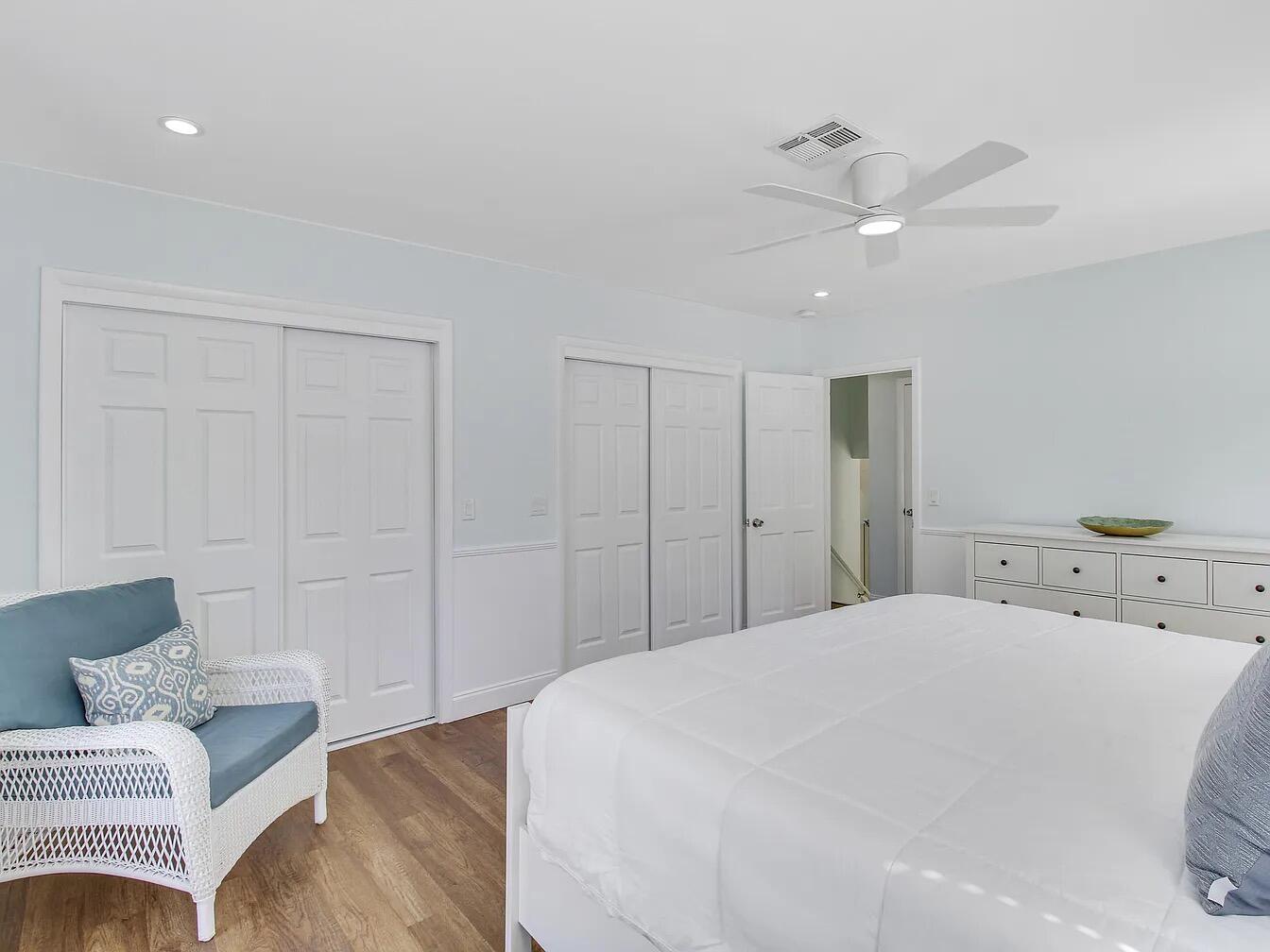 1310 Manor Drive Singer Island, FL 33404 - Photo 19 of 25 a spacious bedroom with a bed and a couch