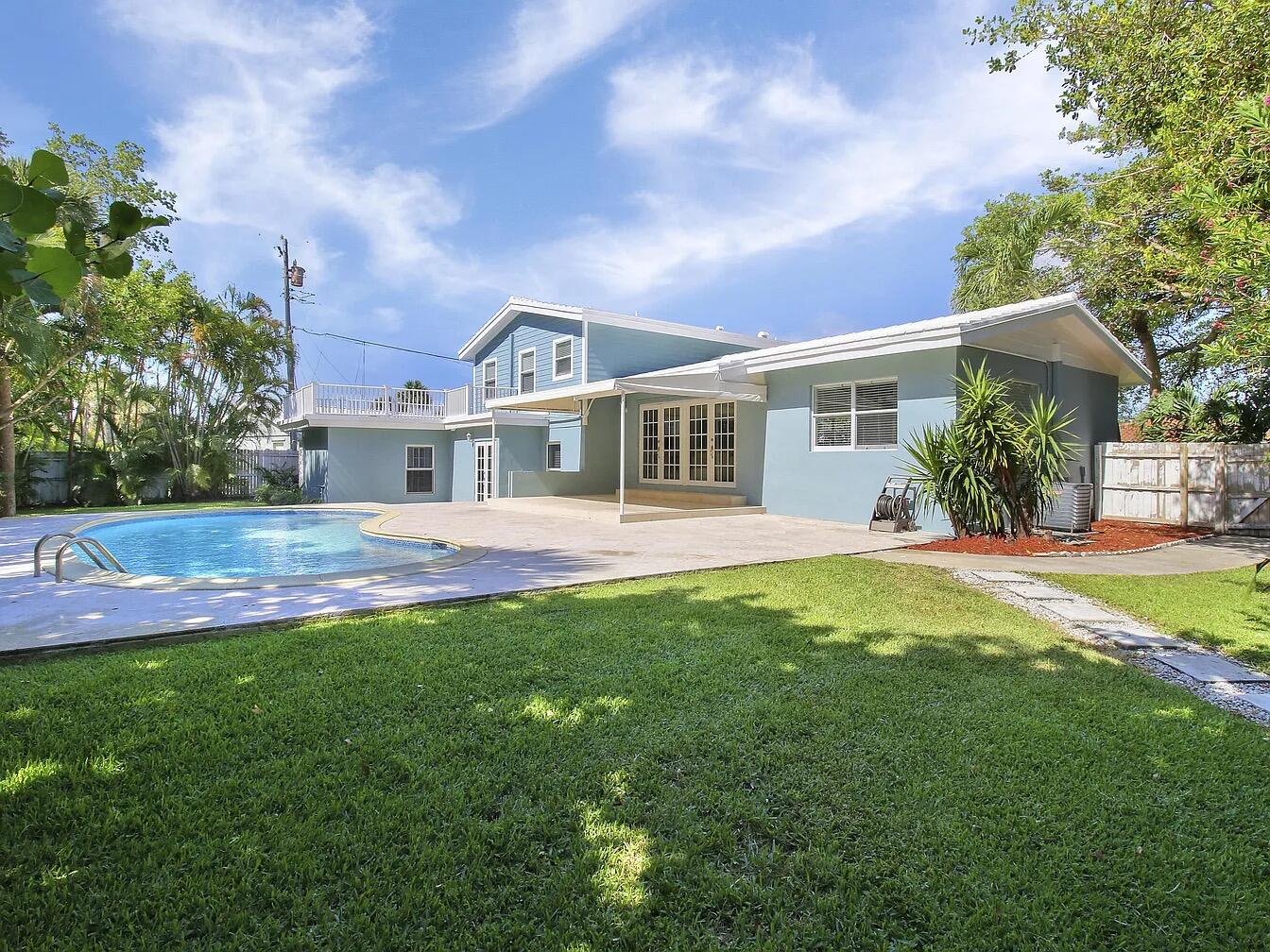 1310 Manor Drive Singer Island, FL 33404 - Photo 24 of 25 a front view of a house with a yard