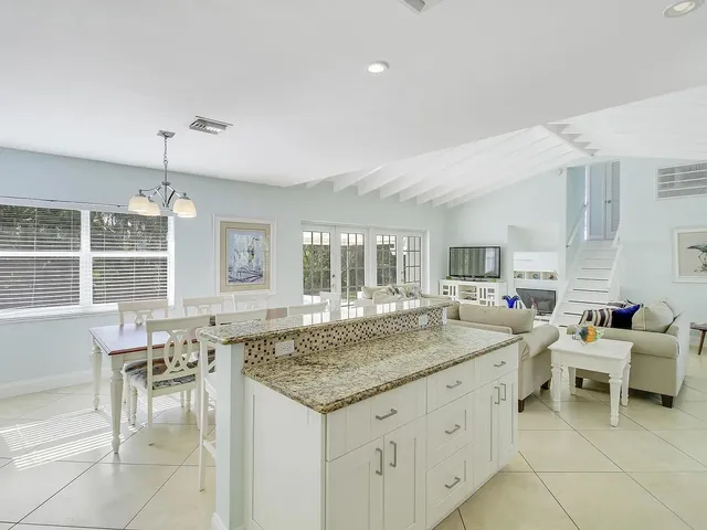a kitchen with center island table and chairs