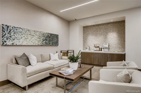 a living room with furniture and large windows