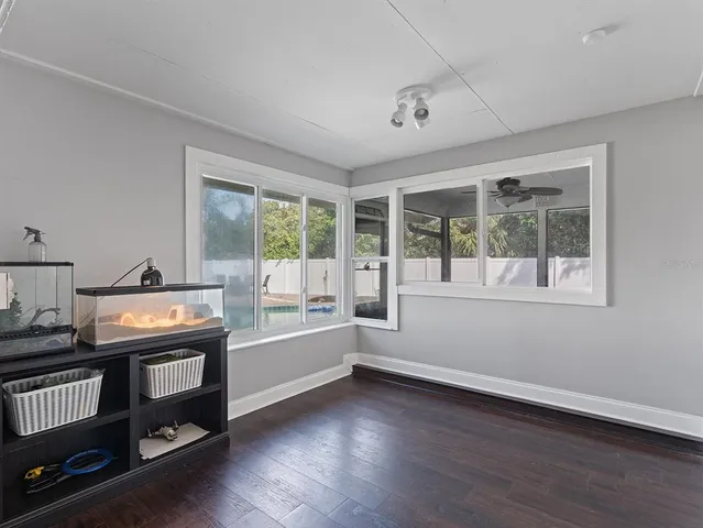 a view of a room with wooden floor and windows
