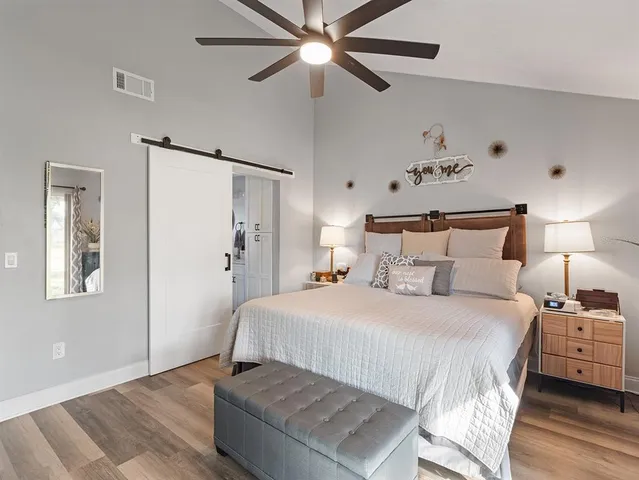 a bedroom with a bed and a chandelier