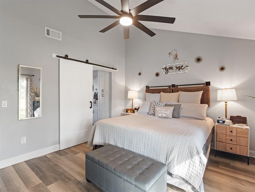 1360 Via Villanova Way Winter Springs, FL 32708 - Photo 18 of 32 a bedroom with a bed and a chandelier