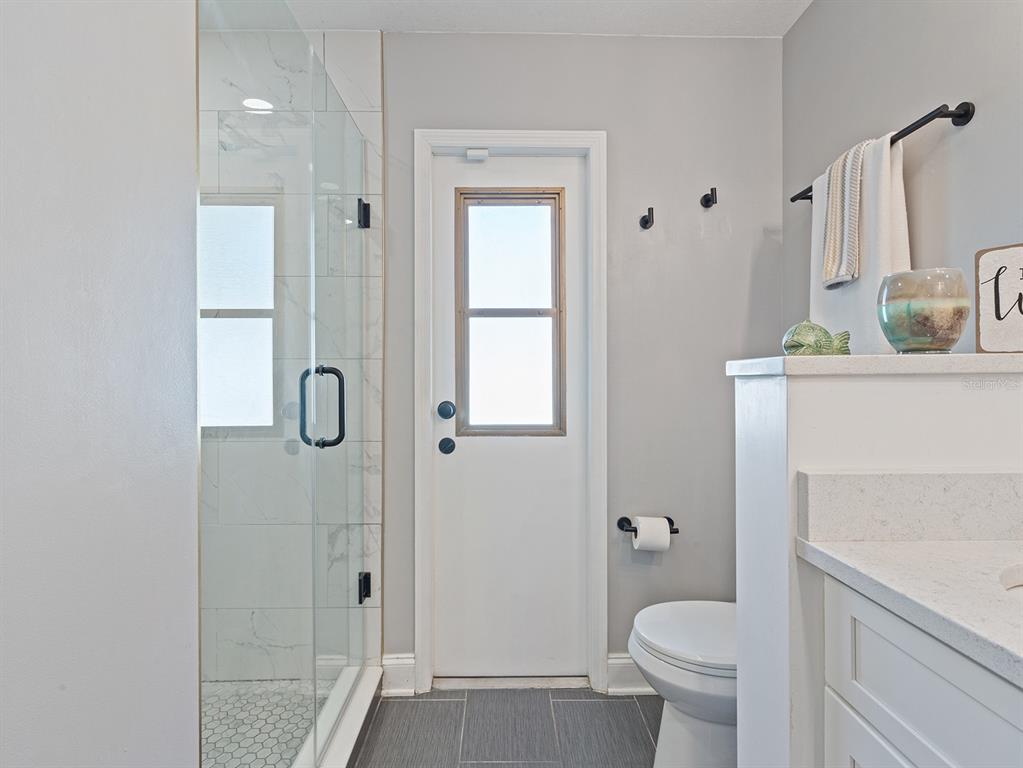 1360 Via Villanova Way Winter Springs, FL 32708 - Photo 20 of 32 a bathroom with a granite countertop sink toilet and shower