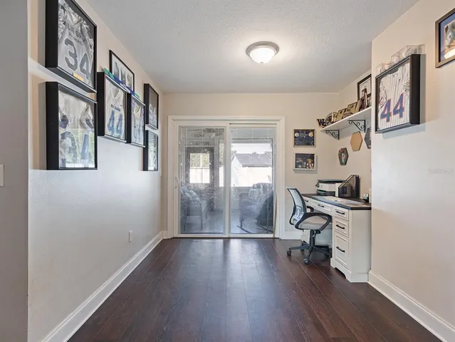 a view of a livingroom with hardwood and workspace