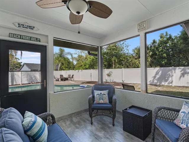 a view of a patio with table and chairs with wooden floor and fence