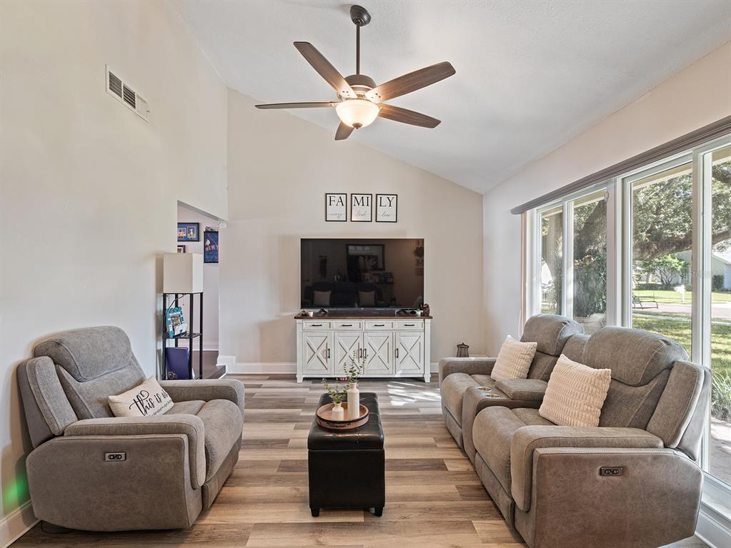 1360 Via Villanova Way Winter Springs, FL 32708 - Photo 7 of 32 a living room with furniture and a flat screen tv